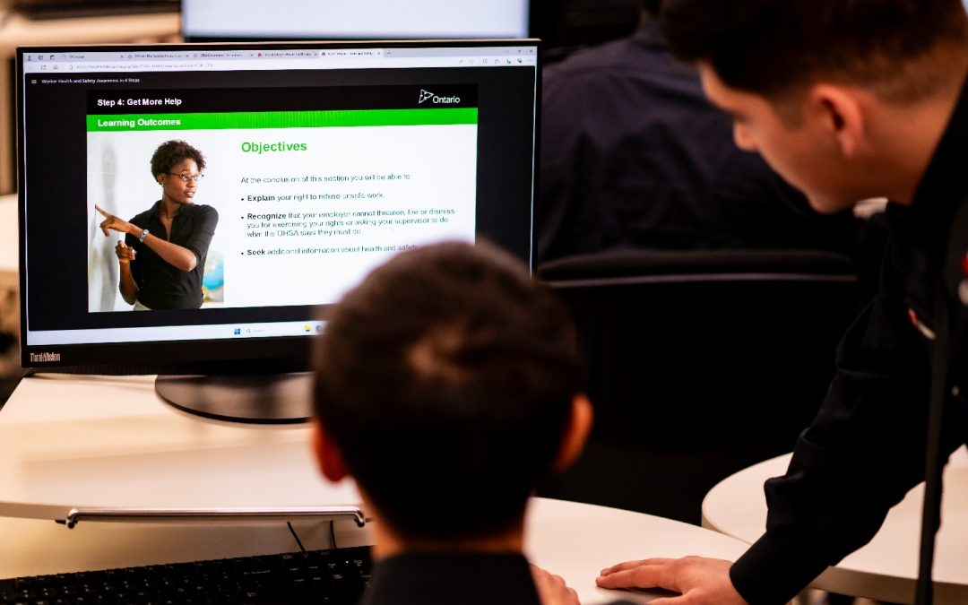 Toronto Police Service recruits view a CPKN course on a computer.