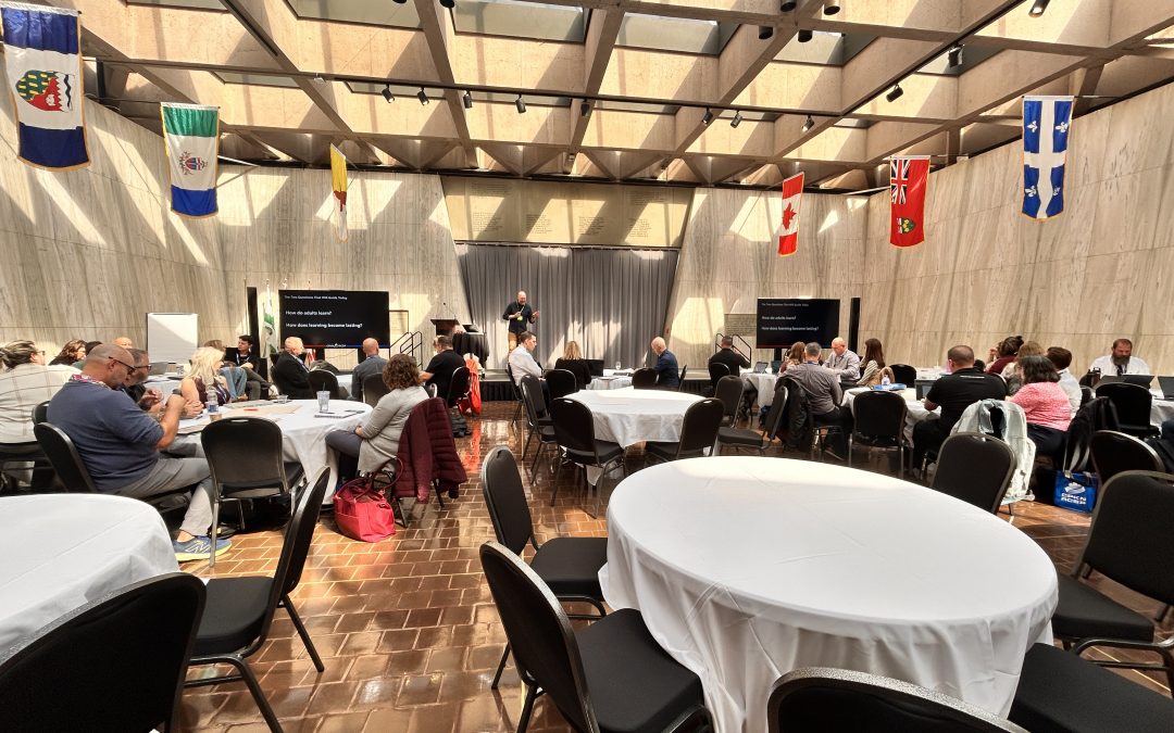 Conference room with attendees listening to a presentation